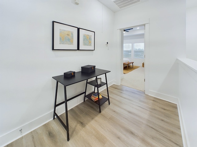 home office with ceiling fan and light wood-type flooring