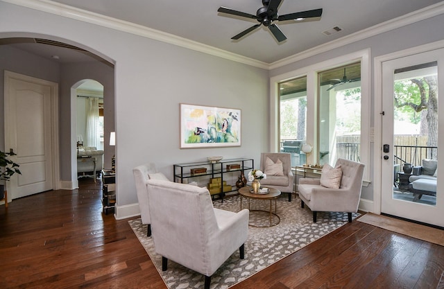 living room with crown molding, ceiling fan, and dark hardwood / wood-style floors