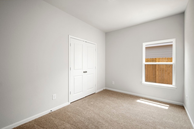 unfurnished bedroom with a closet and carpet floors