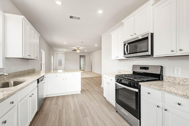 kitchen featuring white cabinetry, sink, ceiling fan, and appliances with stainless steel finishes