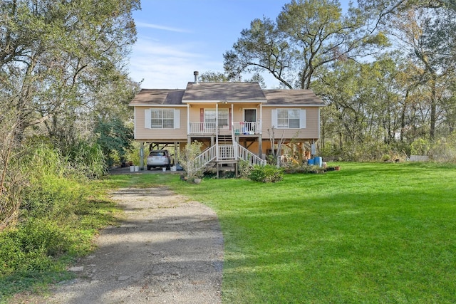 view of front of house with covered porch, a front yard, and a carport