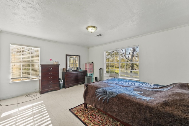 bedroom featuring a textured ceiling and crown molding