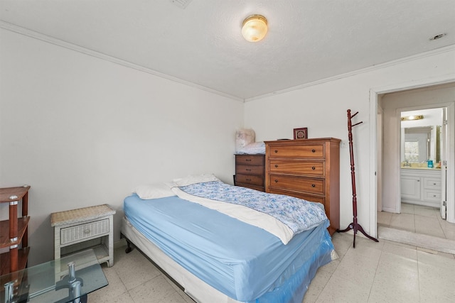 bedroom with ensuite bathroom and crown molding