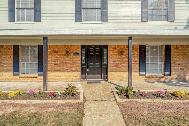 view of exterior entry with a porch