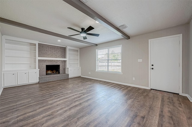 unfurnished living room featuring ceiling fan, beamed ceiling, light hardwood / wood-style floors, a textured ceiling, and a fireplace