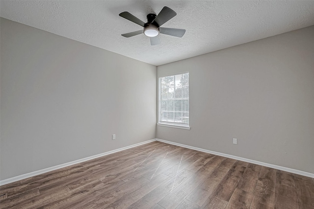 unfurnished room with hardwood / wood-style flooring, ceiling fan, and a textured ceiling