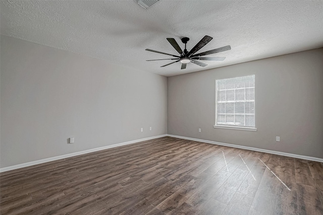 empty room with a textured ceiling, ceiling fan, and dark wood-type flooring