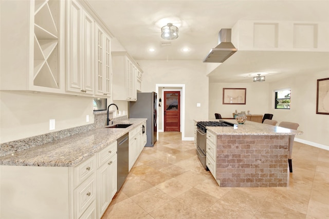 kitchen with sink, a kitchen bar, light stone countertops, and stainless steel appliances