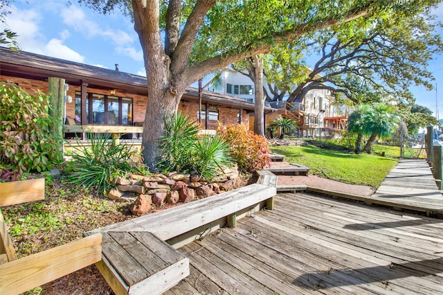 wooden terrace with a lawn