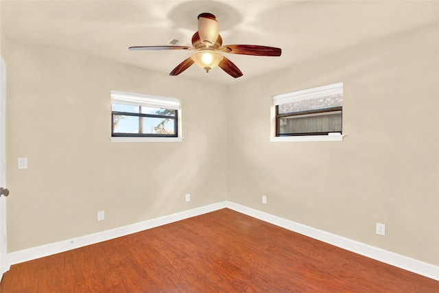 spare room with hardwood / wood-style flooring and ceiling fan