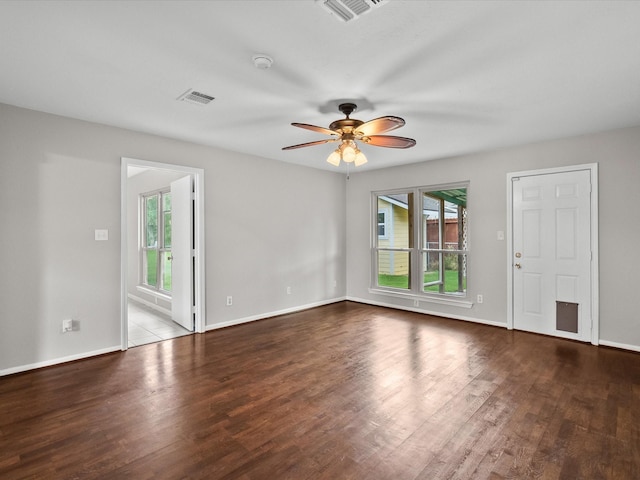 unfurnished room featuring ceiling fan and dark hardwood / wood-style flooring