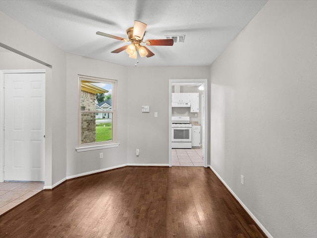 unfurnished living room featuring light wood-type flooring and ceiling fan