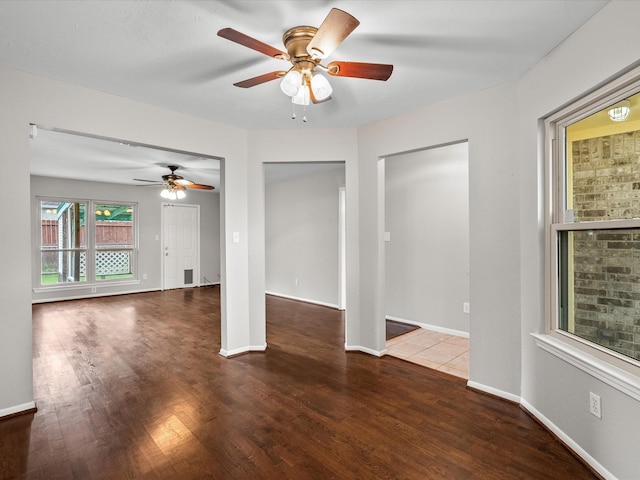 empty room featuring dark hardwood / wood-style floors and ceiling fan