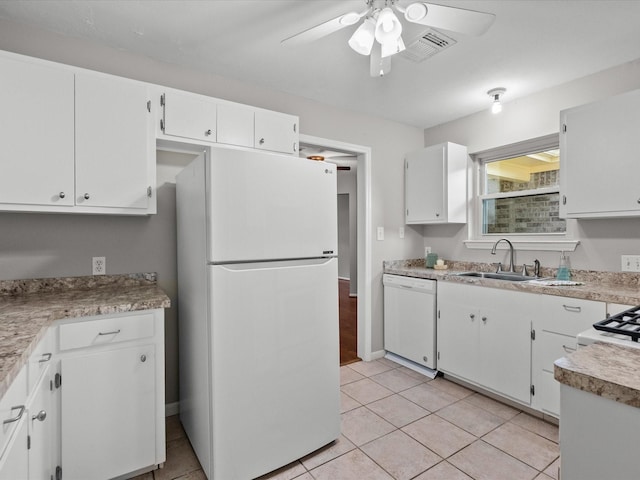 kitchen featuring white appliances, ceiling fan, sink, white cabinets, and light tile patterned flooring