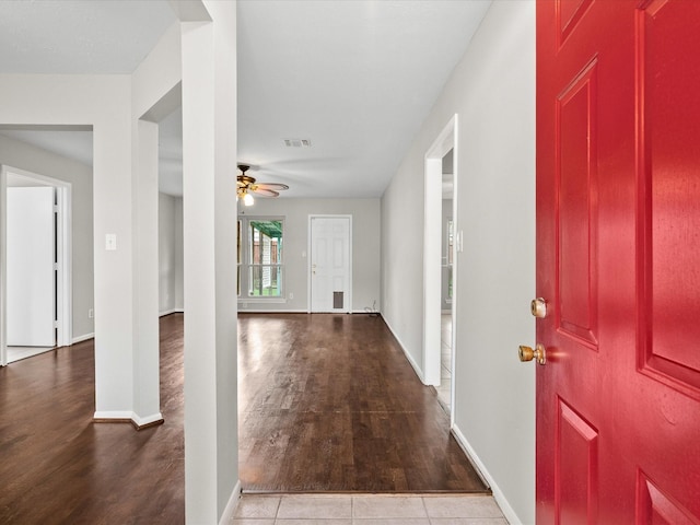 foyer entrance with ceiling fan and light tile patterned floors