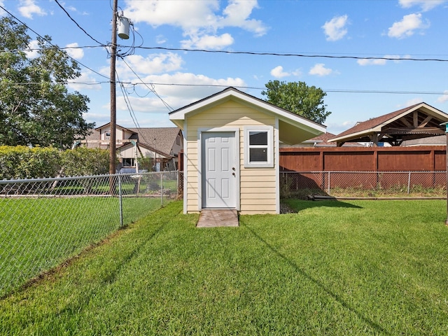 view of outbuilding with a yard