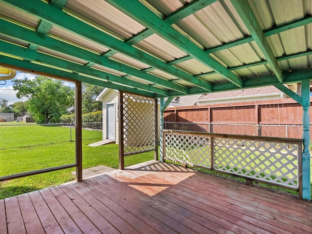 wooden terrace featuring a lawn