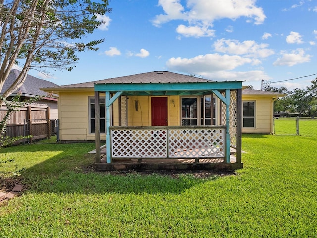 back of house with a yard