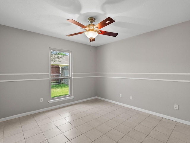 empty room with light tile patterned floors and ceiling fan