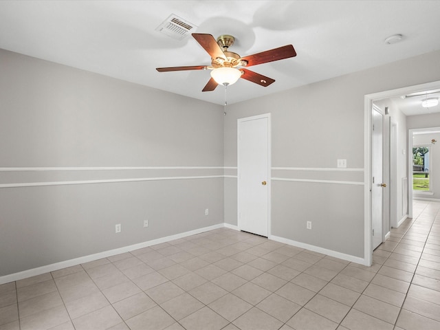 unfurnished room featuring ceiling fan and light tile patterned flooring