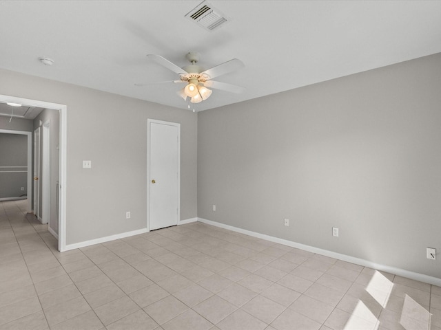 unfurnished room with ceiling fan and light tile patterned flooring