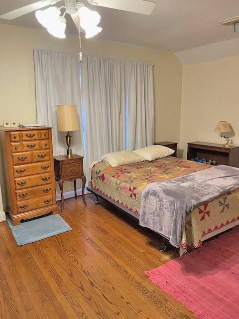 bedroom with hardwood / wood-style flooring and ceiling fan