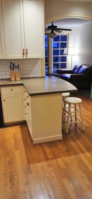 kitchen featuring backsplash, white cabinetry, and light wood-type flooring