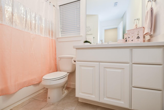 full bathroom with tile patterned floors, vanity, toilet, and shower / bath combo with shower curtain