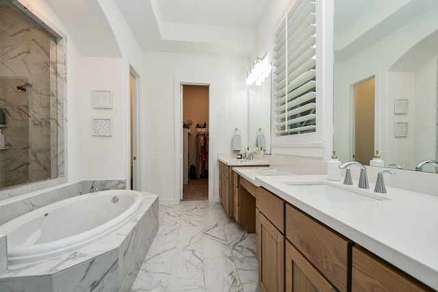 bathroom featuring vanity and shower with separate bathtub