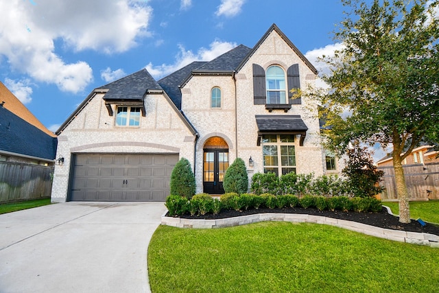 view of front of home featuring a front yard and a garage