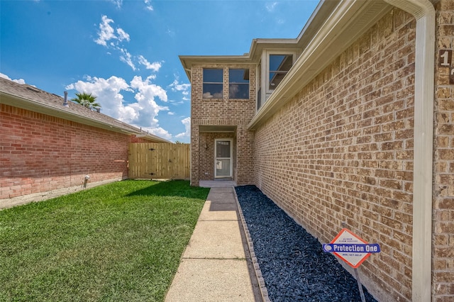 entrance to property with a lawn