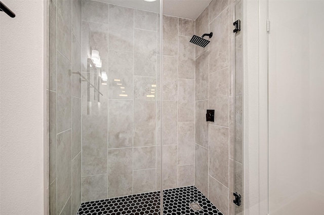 bathroom with a shower with door