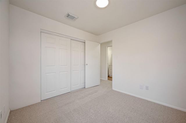 unfurnished bedroom featuring a closet and carpet floors