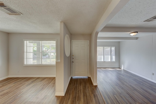 entryway featuring wood-type flooring and a textured ceiling