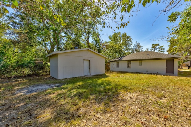 rear view of house featuring a lawn