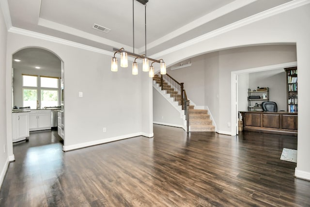 interior space featuring a raised ceiling, dark wood-type flooring, and crown molding