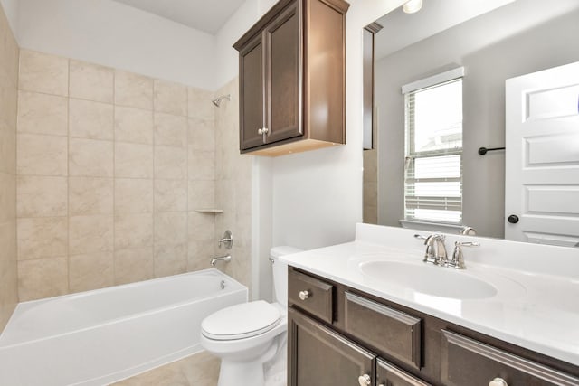 full bathroom featuring toilet, tile patterned flooring, vanity, and tiled shower / bath