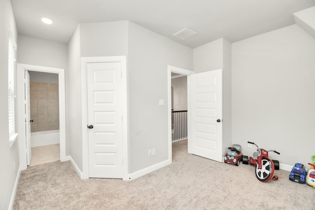 carpeted bedroom featuring connected bathroom