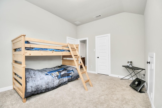 bedroom with carpet flooring and lofted ceiling