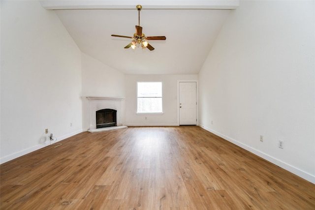 unfurnished living room with vaulted ceiling with beams, light hardwood / wood-style floors, and ceiling fan