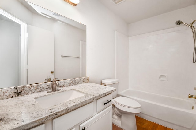 full bathroom featuring wood-type flooring, vanity, toilet, and  shower combination