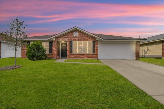 ranch-style home with a yard and a garage