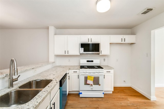 kitchen featuring white cabinets, stainless steel dishwasher, gas range gas stove, and sink