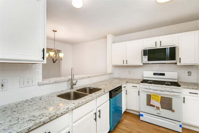 kitchen with stainless steel dishwasher, sink, pendant lighting, white cabinets, and white stove