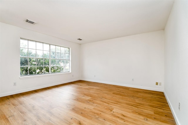 unfurnished room featuring hardwood / wood-style floors