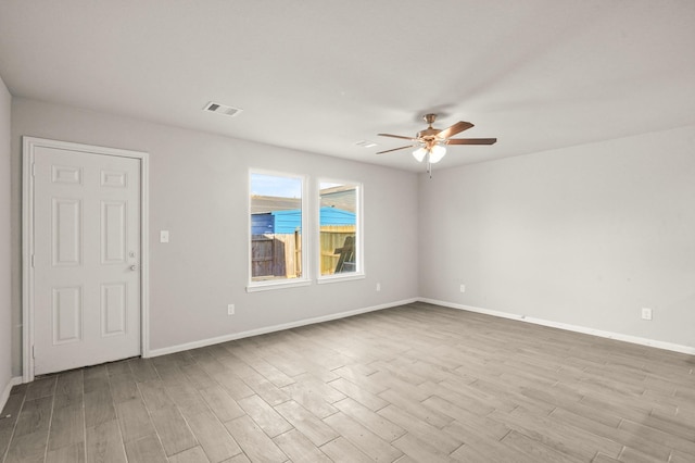 spare room featuring light hardwood / wood-style flooring and ceiling fan