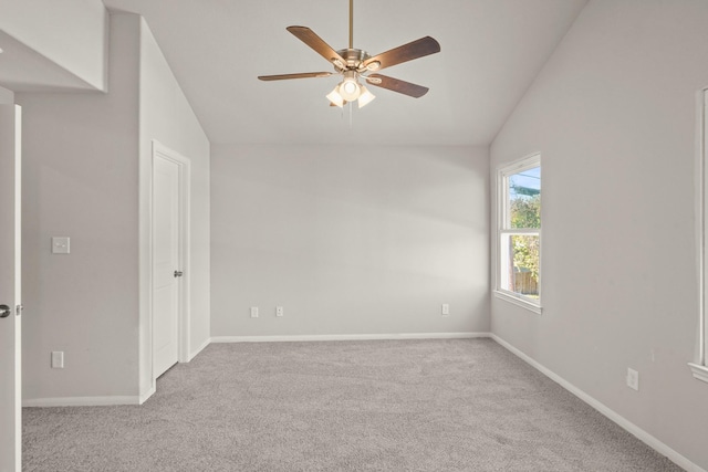 carpeted empty room with ceiling fan and vaulted ceiling