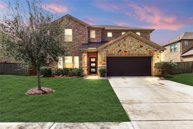 view of front facade with a lawn and a garage