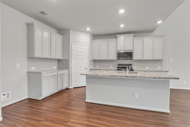 kitchen featuring sink, white cabinetry, a kitchen island with sink, and appliances with stainless steel finishes