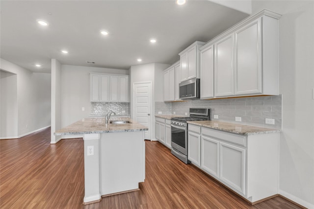 kitchen featuring sink, a center island with sink, white cabinets, and appliances with stainless steel finishes